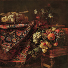 Francesco Noletti, detto il Maltese (La Valletta 1611 circa - Roma 1654), Composizione con tappeto, canditi, cesto di frutta e vaso di fiori, 1650 circa, olio su tela.