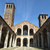 Facade and colonnade of the Romanesque Cathedral of Saint Ambrogio, Milan | Photo: Paolo Bona / Shutterstock.com