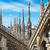 White marble statues on the roof of famous Cathedral Duomo di Milano, Italy | Photo: Pavel Vakhrushev