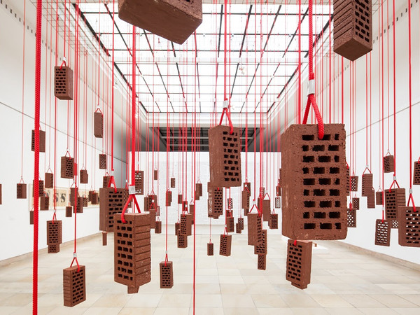 Kendell Geers, HangingPiece, 1993, brick, rope and metal hooks, dimensions variable, installation view at Haus der Kunst, Munich