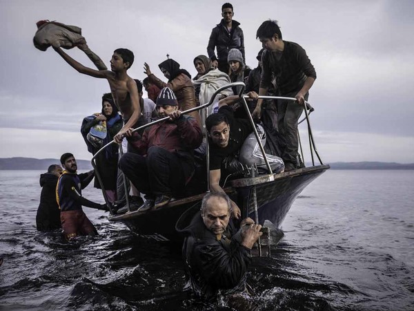 Sergey Ponomarev: Migrants arrive by a Turkish boat near the village of Skala, on the Greek island of Lesbos. Monday 16 November 2015. Series: Europe Migration Crisis, 2015