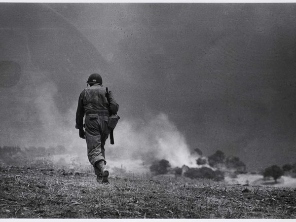 Robert Capa, Soldier walking through field on recconnaissnace mission, near Troina, Sicily, Italy, August 4-5, 1943 © International Center of Photography/Magnum Photos