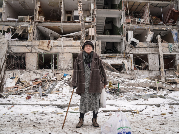 Andrey Bashtovoy, Larysa Oleksandrivna, 75, stands in front of the ruined facade of her house in the Pavlove Pole residential area