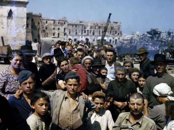 Sfollati italiani attendono in un punto di raccolta ad Anzio l’imbarco sulle navi che li porteranno a Napoli, giugno 1944