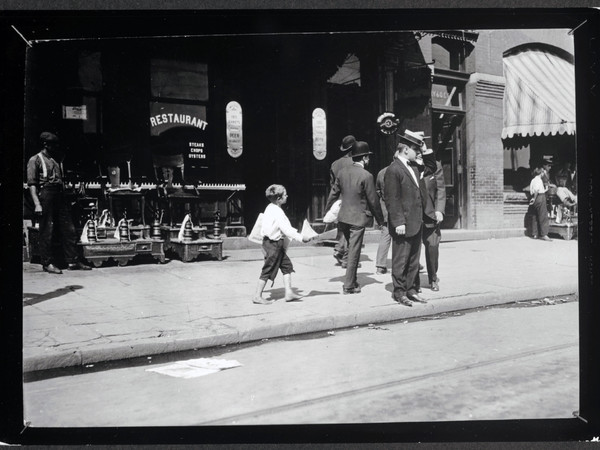 Lewis Hine, Candid shot of Newsie selling papers on street, 1912, gelatin silver print, 11.4 x 16.2 cm