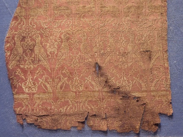 Funerary Robe, Fragments of the funerary robe of Henry VI, red-and-gold lampas silk, tomb of Henry VI, Palermo, Sicily, 1197 AD | © The Trustees of the British Museum, London