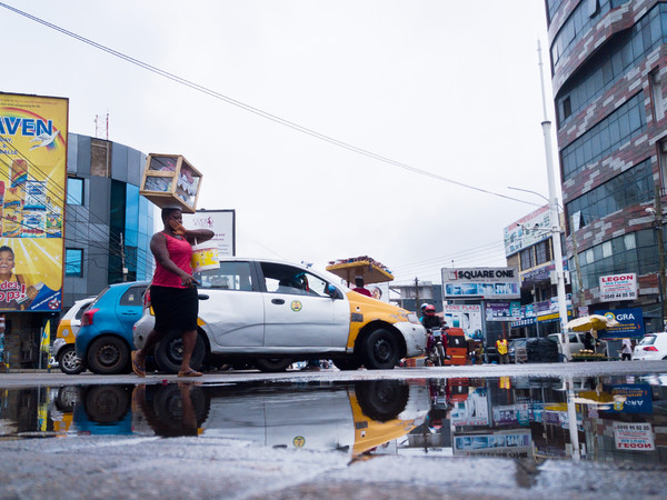 Festus Jackson Davis, <em>After the Rain</em>. Woman dancing across puddles, Osu, Accra, Ghana