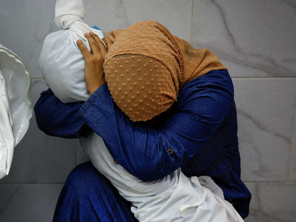 World Press Photo of the Year |  Mohammed Salem, A Palestinian Woman Embraces the Body of Her Niece 