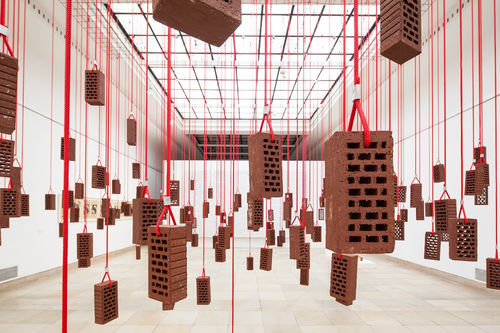 Kendell Geers, HangingPiece, 1993, brick, rope and metal hooks, dimensions variable, installation view at Haus der Kunst, Munich