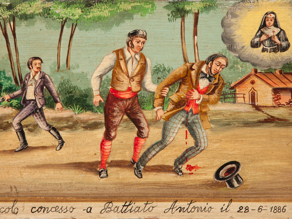 Miracolo concesso a Battiato Antonio il 28 - 6 - 1886, Sicilia, Olio su tavola, 40 x 24.1 cm | Il 28 giugno 1886 Antonio Battiato viene ferito a colpi di arma da fuoco da un bandito siculo e soccorso da un suo amico. L’uomo elegantemente vestito (papillon, panciotto e cilindro) e sanguinante, si affida alla grazia di Santa Rita, ritratta in alto a destra della tavoletta