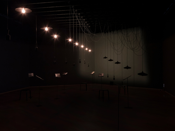 Shilpa Gupta, Listening Air , 2019-2023 Multi-channel sound installation, speakers, microphones, lights, printed text on metal stands Dimensions variable Courtesy of Neugerriemschneider I Ph. Staatliche Museen zu Berlin, ationalgalerie / Luca Girardi