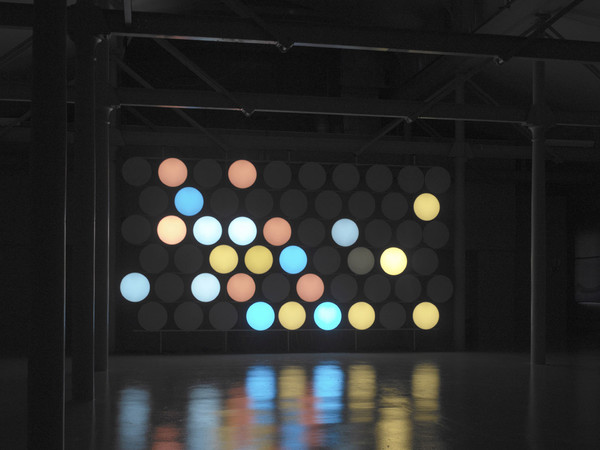 Carsten Höller, Phi Wall II, 2002, Tubi di vetro con neon bianco e marrone, vetro acrilico, filtri di colori, alluminio, legno, unità di controllo, cavi, Dimensioni variabili ø (ciascun disco luminoso ): 56 cm, 38 dischi luminosi minimo | Foto © Stefan Frank-Jensen, 2003 - Courtesy dell’artista